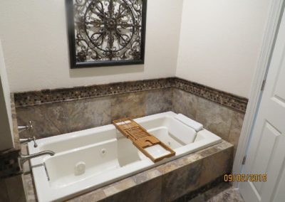 Custom tile-backed tub.