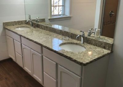 A granite-topped master bathroom counter.