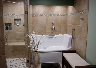 A tub room with a custom ceramic tile flooring.